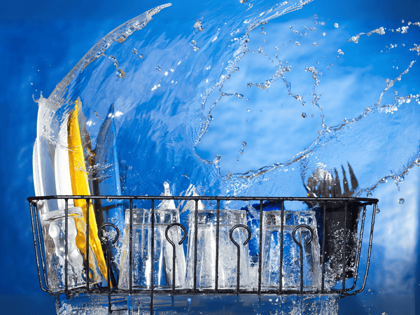 Commercial dishwashers in action with water splashing, showcasing efficient and powerful cleaning performance
