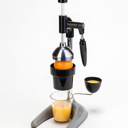 Hamilton Beach HBJ0932 manual citrus juicer — in use juicing an orange